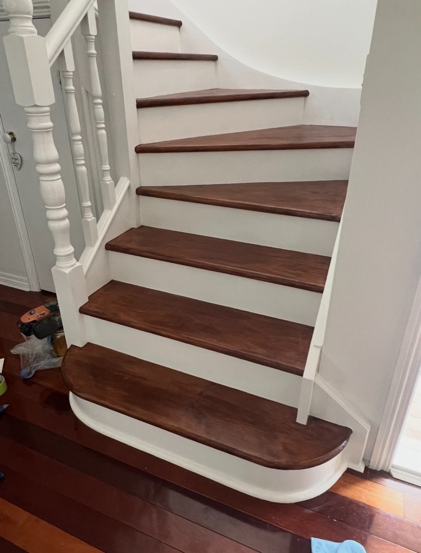 Finished staircase with stained treads and crisp white risers