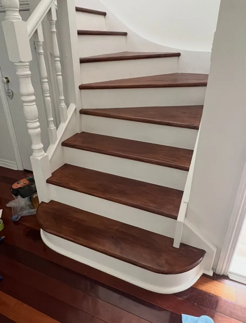 Finished staircase with stained treads and crisp white risers